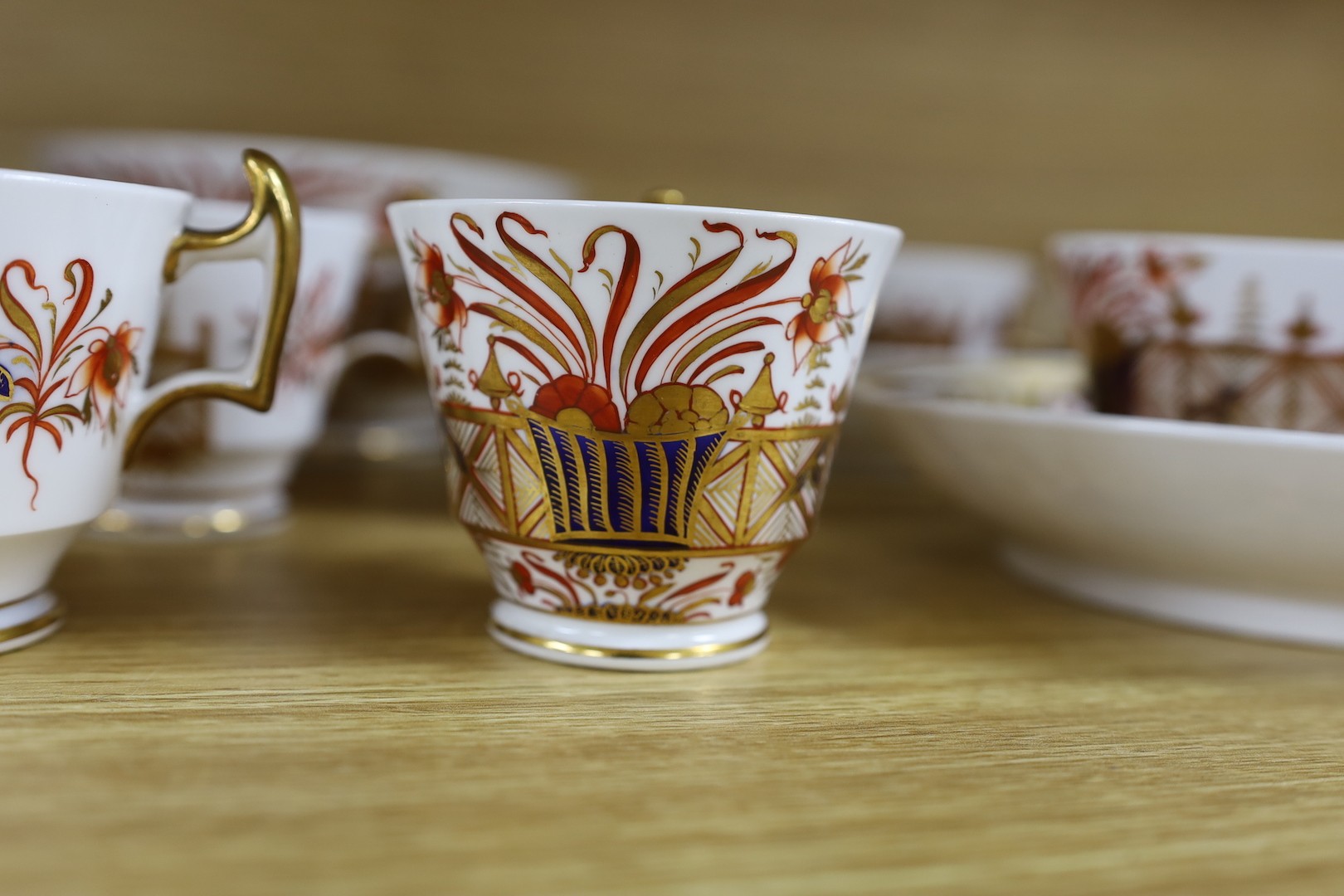 A Spode part Imari tea service consisting of six London shape tea cups, coffee cups and saucers, two graduated saucer dishes and a bowl pattern 1495